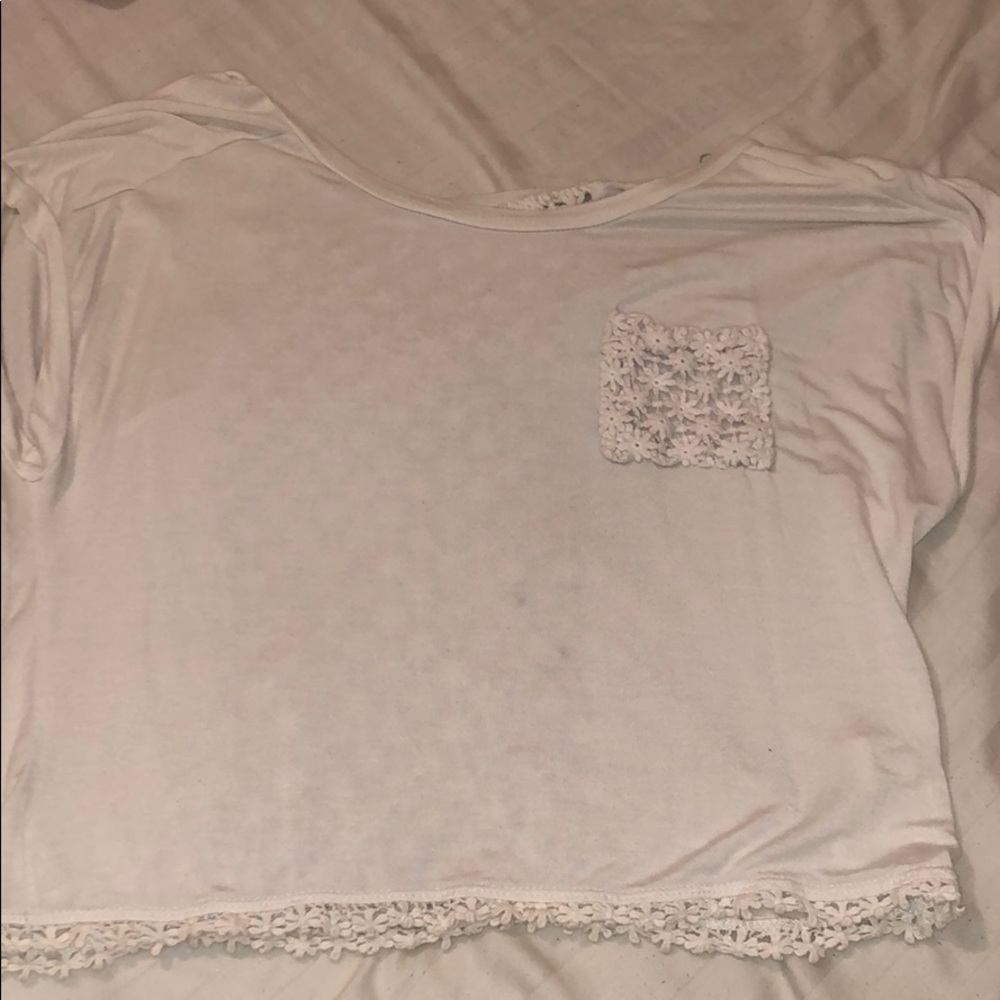 White top with floral designed lace and open back